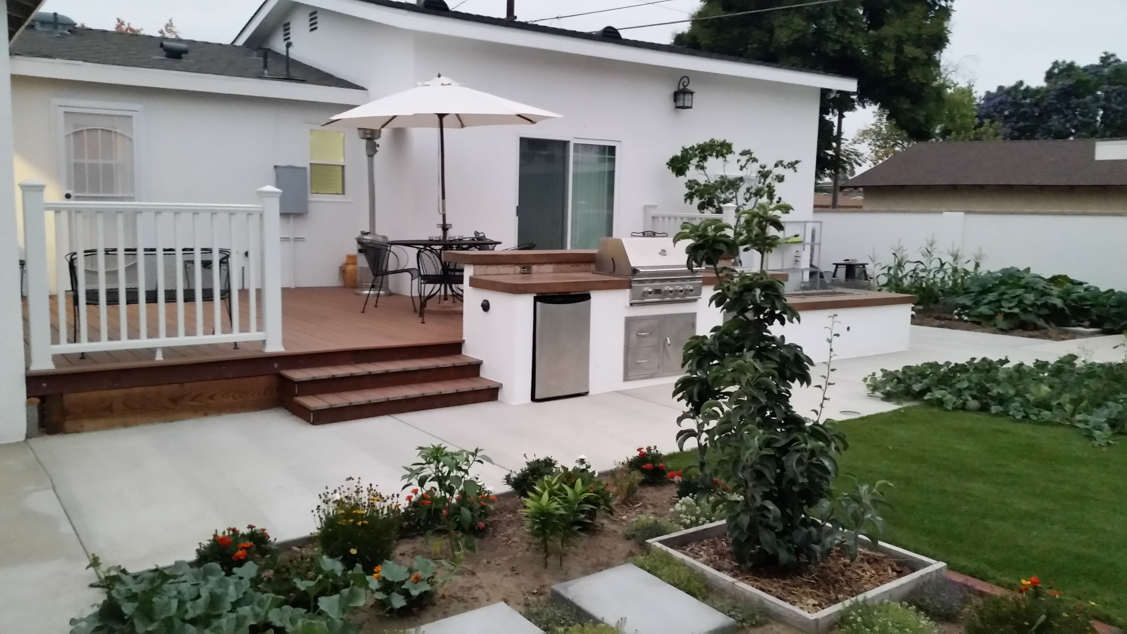 Completed room extension with outdoor kitchen and landscaping